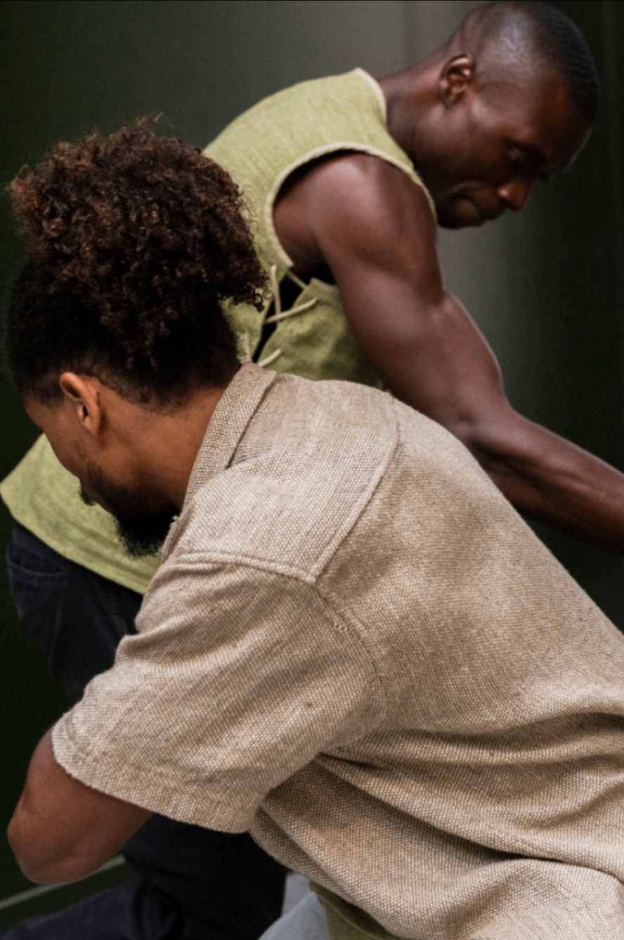 Two makers side by side in hemp garments — a sage woven vest and a sand-coloured textured shirt